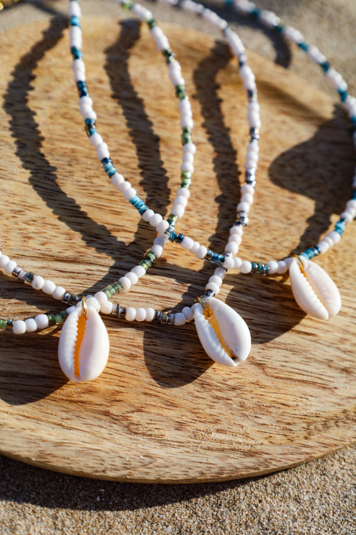 Collier composé de perles de petites rocailles de différentes couleur avec pendentif cauri